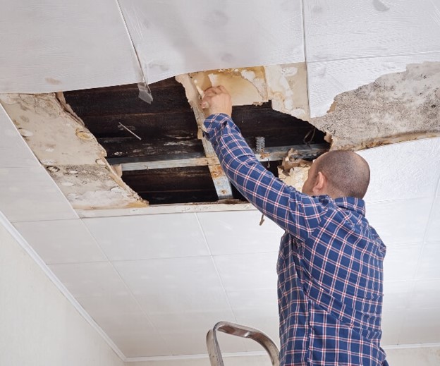 Man repairing a leaking roof