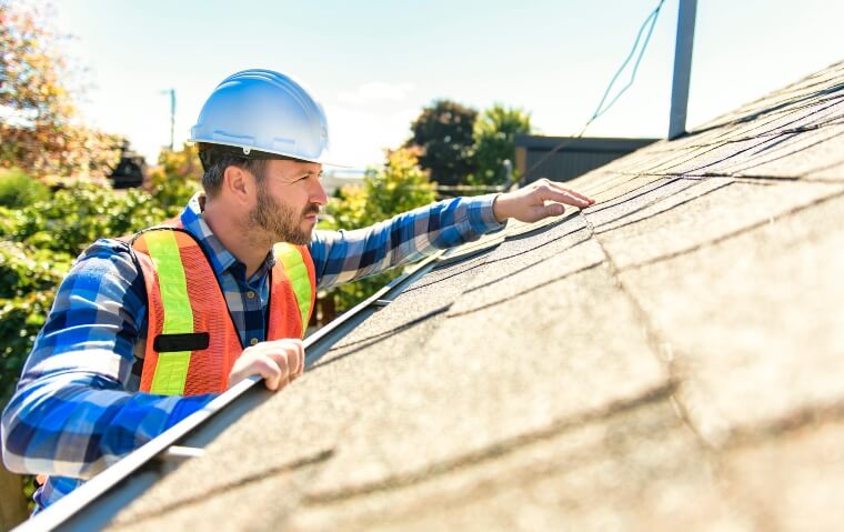 roof inspector checking roof