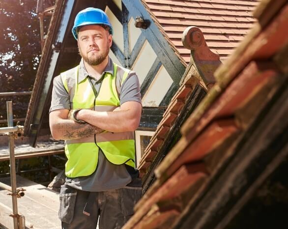 Roof Repairman standing near the site - Gresham Roofing and Construction